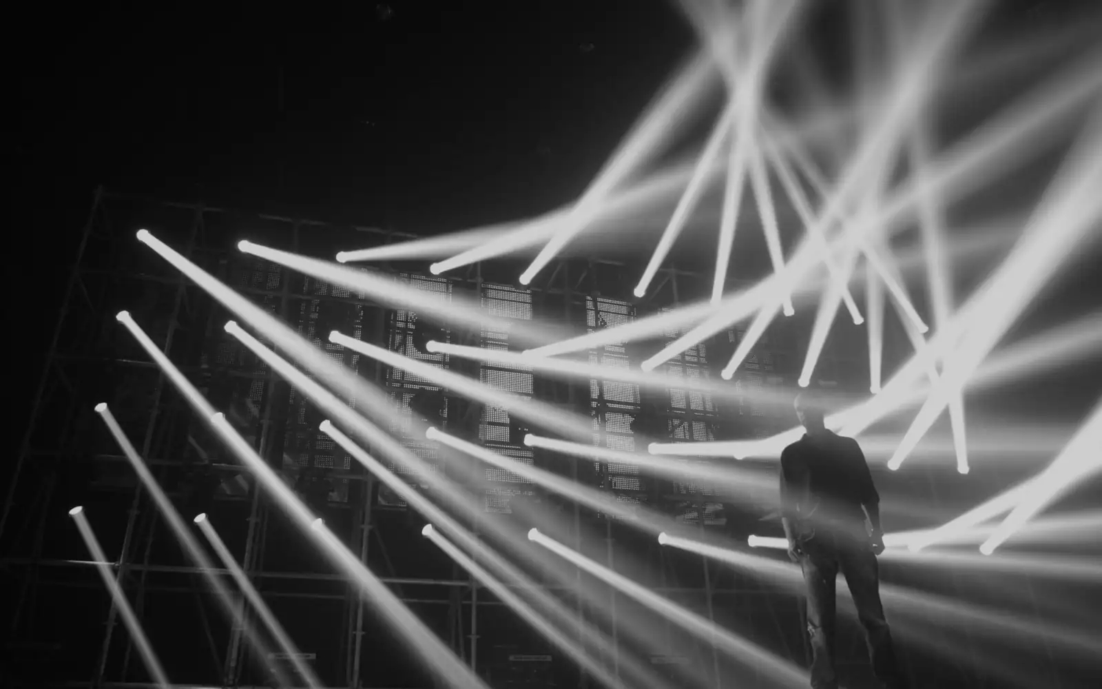 Light beams across a dark stage